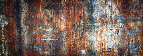 Rusty metal wall, old sheet of iron covered with rust with multi-colored paint photo