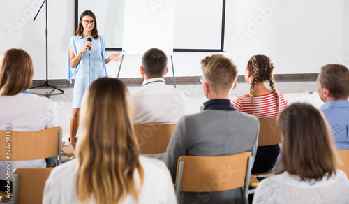 Female student answering in front of student group