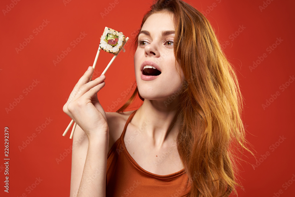woman holding chopsticks roll woman holding chopsticks roll