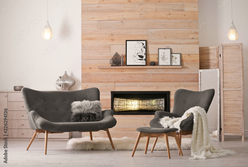 Cozy living room interior with comfortable furniture and decorative  fireplace фотография Stock | Adobe Stock