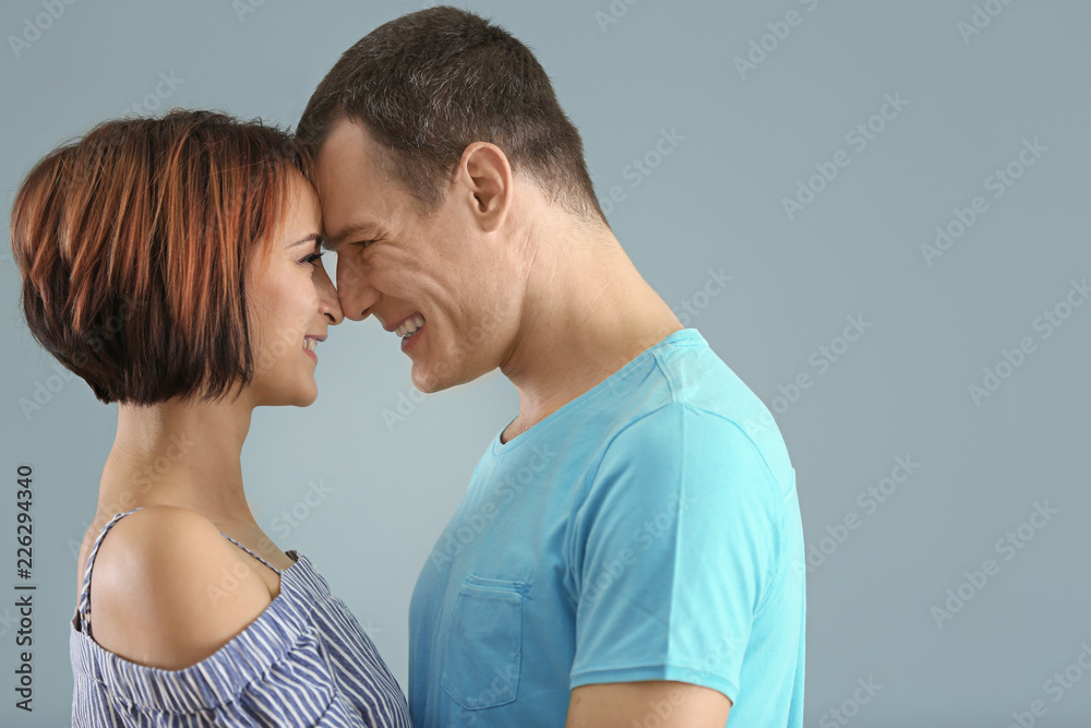 Fototapeta premium Portrait of cute loving couple on color background