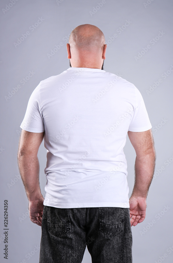 Fat man on grey background. Weight loss Fat man on grey background. Weight loss