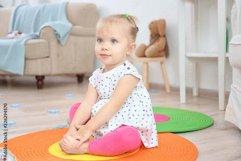 Fototapeta premium Adorable little girl playing indoors
