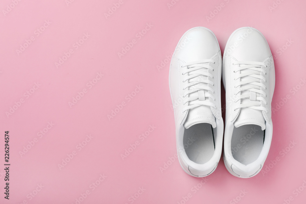 Pair of sneakers on color background, flat lay. Space for text Pair of sneakers on color background, flat lay. Space for text