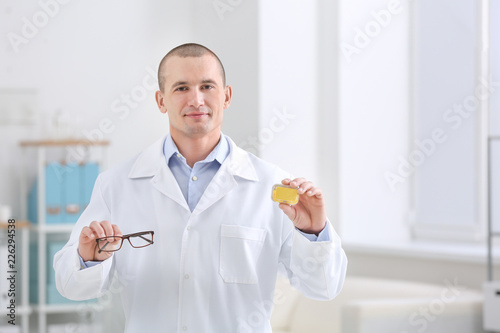 Male doctor holding contact...