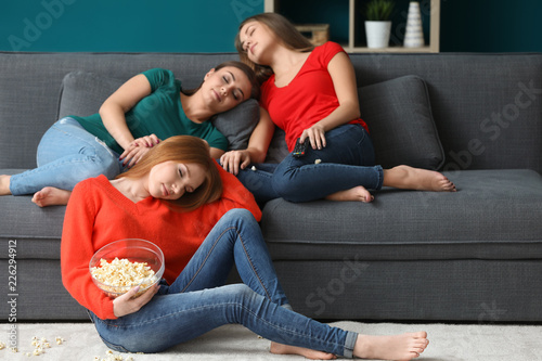 Young women fell asleep while watching TV at home