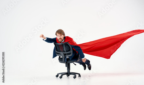 man riding on a chair with a red sheet