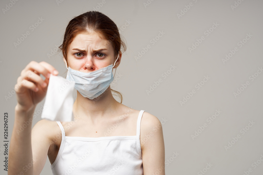 woman wearing a medical mask holding a napkin in her hand woman wearing a medical mask holding a napkin in her hand