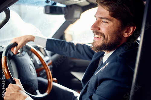 man in a suit sits behind the wheel of a car © SHOTPRIME STUDIO