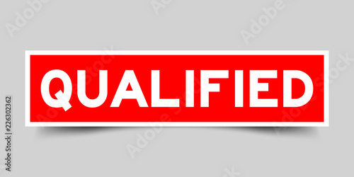 Red color sticker in word qualified on gray background