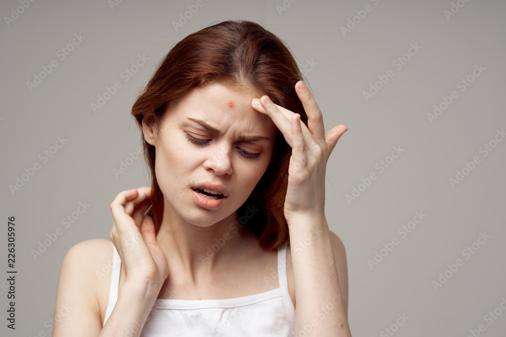 woman with red pimple on the forehead woman with red pimple on the forehead