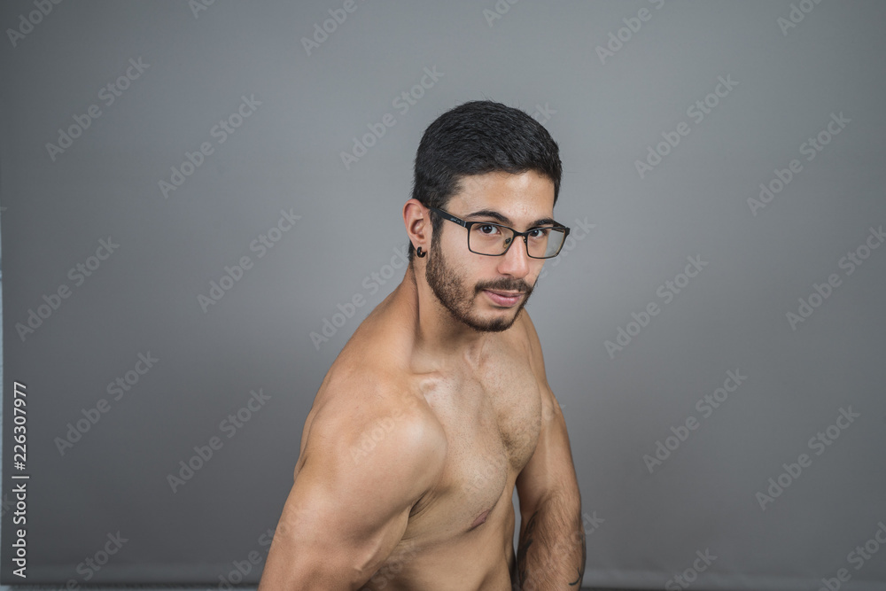 Muscular young man posing with definition Muscular young man posing with definition