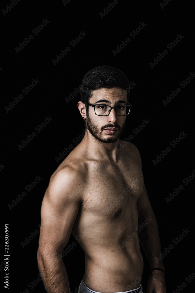 Fototapeta premium Muscular young man posing with definition
