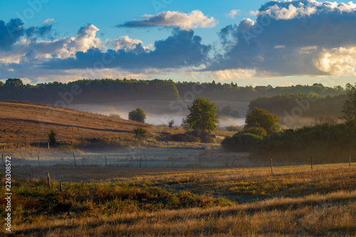 Fototapeta Naklejka Na Ścianę i Meble -   meadows on a magnificent misty and sunny morning. landscape picture resembling Italian Tuscany. Autumn, Poland, Drawsko Lake District