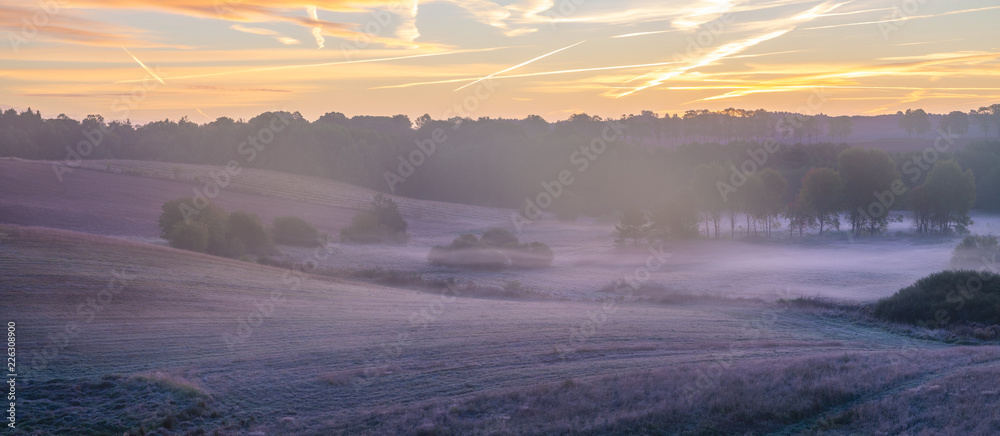 beautiful, multicolored dawn above the panorama of fields and meadows. landscape picture resembling Italian Tuscany. Autumn-Poland, Drawsko Lake District