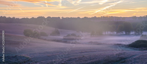 Fototapeta Naklejka Na Ścianę i Meble -  beautiful, multicolored dawn above the panorama of fields and meadows. landscape picture resembling Italian Tuscany. Autumn-Poland, Drawsko Lake District