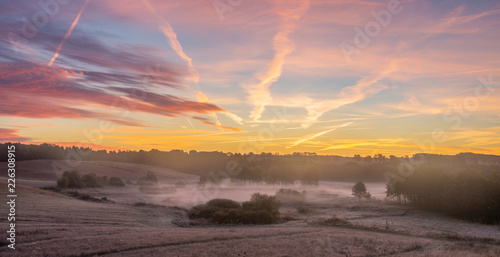 Fototapeta Naklejka Na Ścianę i Meble -  beautiful, multicolored dawn above the panorama of fields and meadows. landscape picture resembling Italian Tuscany. Autumn-Poland, Drawsko Lake District