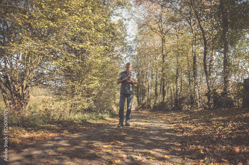 Einsamer Mann auf einem Weg im Wald auf der Suche nach dem richtigen Weg 