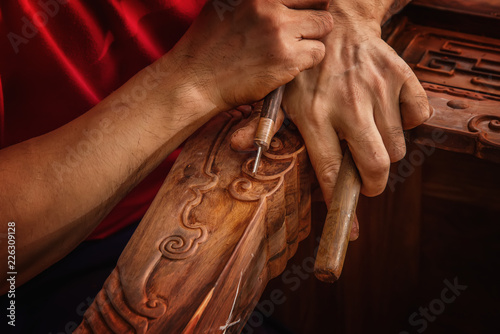 Fotografia, Obraz Carving and polishing of mahogany furniture