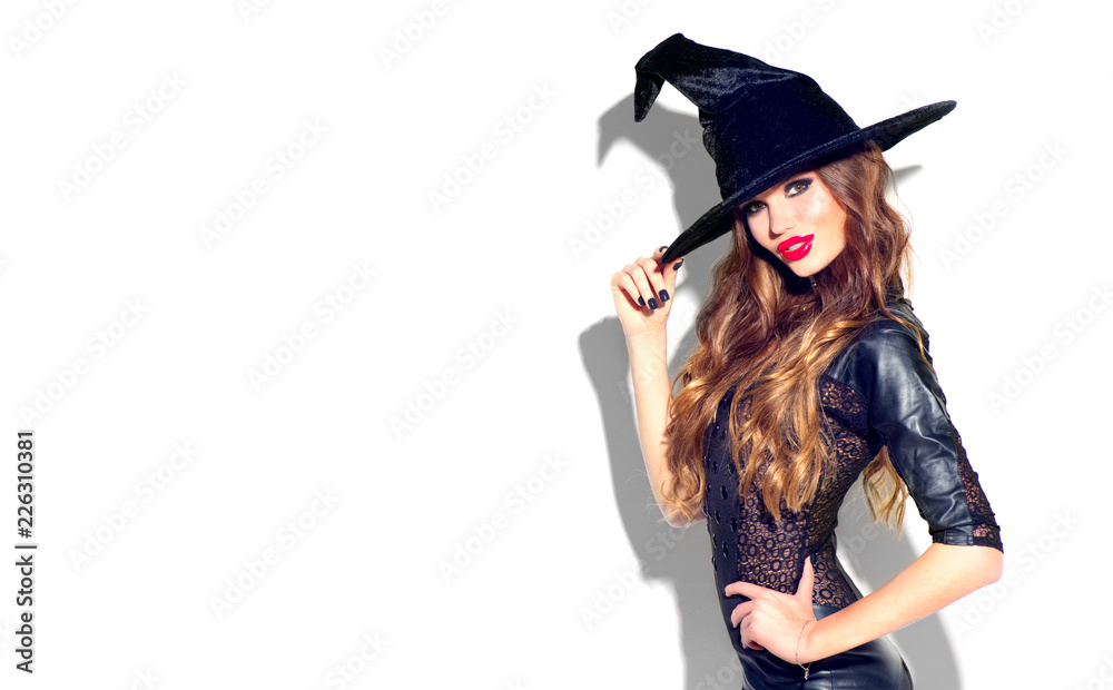 Halloween. Sexy witch with bright holiday makeup. Beautiful young woman  posing in witches costume over white background Stock Photo | Adobe Stock