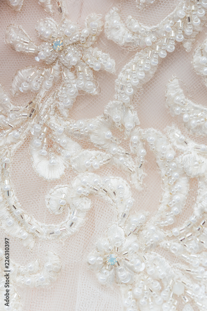 Beadwork details of a wedding dress Beadwork details of a wedding dress
