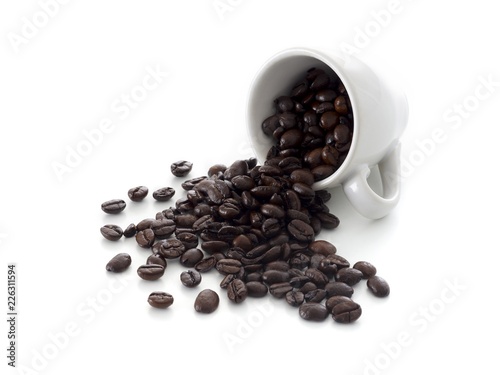 Coffee beans spilling from cup