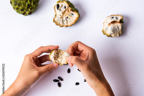 Female eating Custard apple fruit first person
