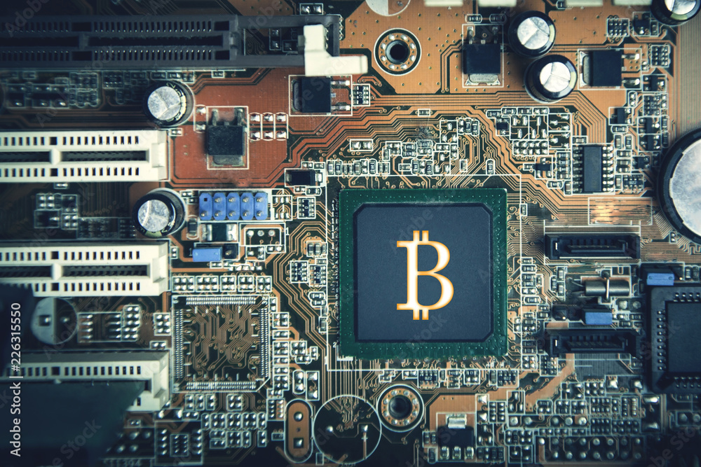 Bitcoin symbol on computer motherboard. Bitcoin Technology Concept