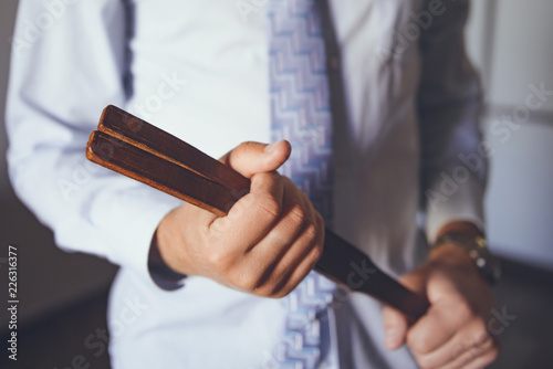 Man with leather tawse. Strict headmaster with tawse. Corporal punishment in school. BDSM concept. Adult role game concept. strict school teacher with tawse © 47cb06083e875
