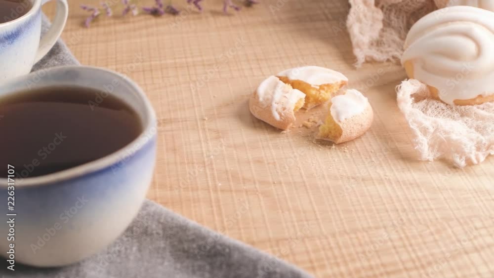 Coockies with egg white cover. Portuguese sweets known as cavacas served with tea on ceramic cups. Coockies with egg white cover. Portuguese sweets known as cavacas served with tea on ceramic cups.