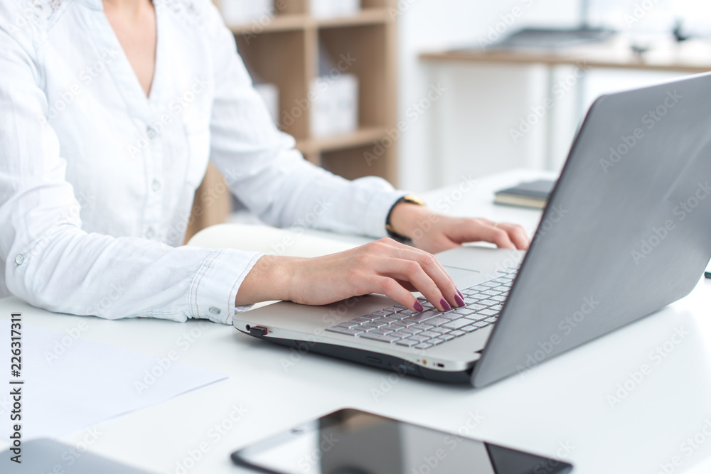 Businesswoman typing on laptop at workplace Woman working in office hand keyboard Businesswoman typing on laptop at workplace Woman working in office hand keyboard
