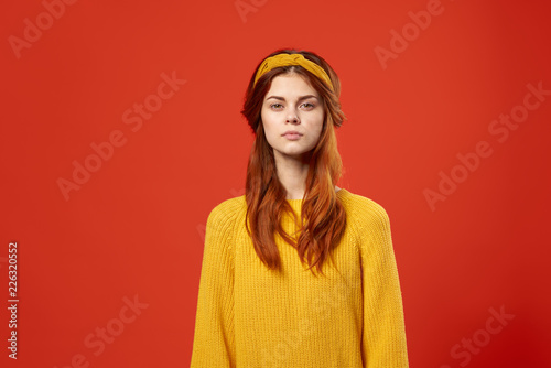 woman in a yellow sweater and headband