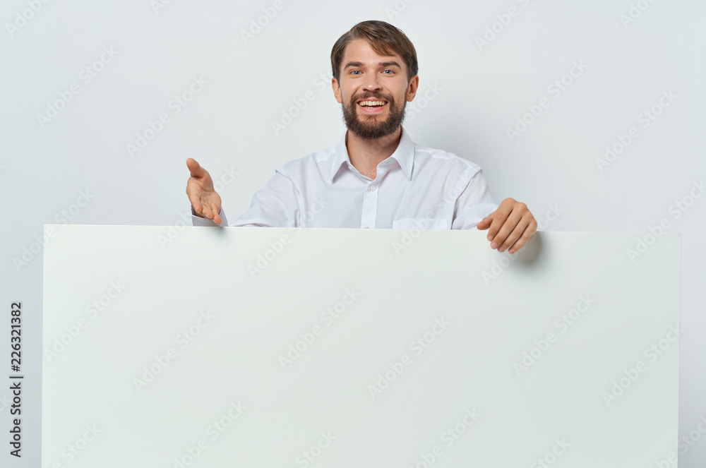 man in blue shirt shows on a sheet of paper man in blue shirt shows on a sheet of paper