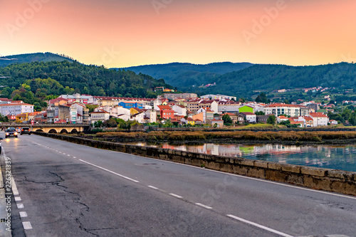 Sunset view of Spanish highway and the colorful seaside village of Noia.