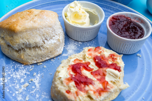 english cream tea with scones, clotted cream, marmelade and tea photo