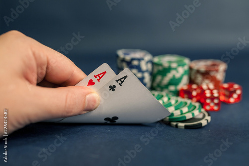 aces in hand and pocker chips