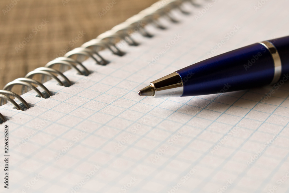 Pen with notebook on wooden table . Close up. Concept of education Pen with notebook on wooden table . Close up. Concept of education