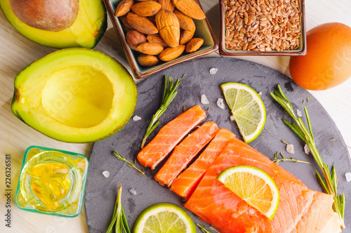 Fish oil capsules and food Omega 3 sources - fish, avocado, nuts, linen seeds, egg