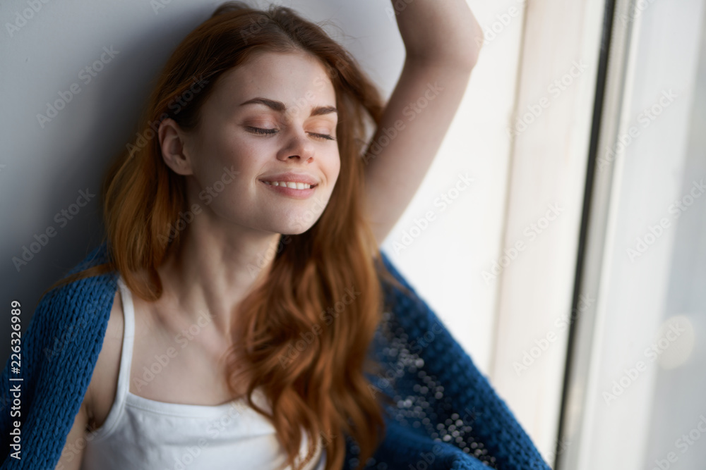 woman with eyes closed sitting near the window woman with eyes closed sitting near the window