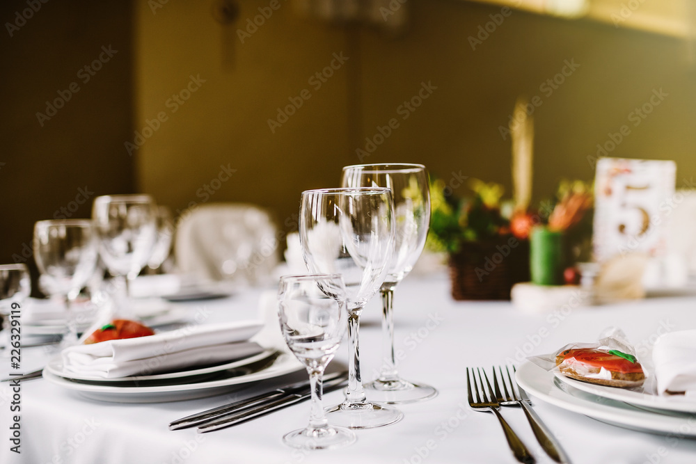 Close-up of folded napkin and empty glasses. Close-up of folded napkin and empty glasses.