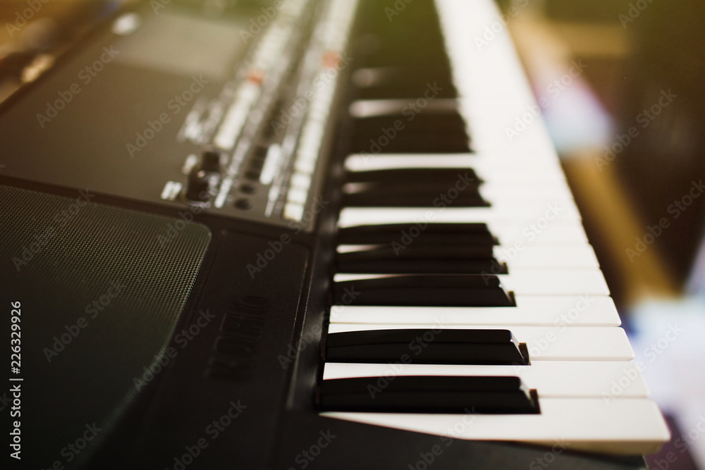 Synthesizer knobs. piano keys close-up. electronic musical instr Synthesizer knobs. piano keys close-up. electronic musical instr