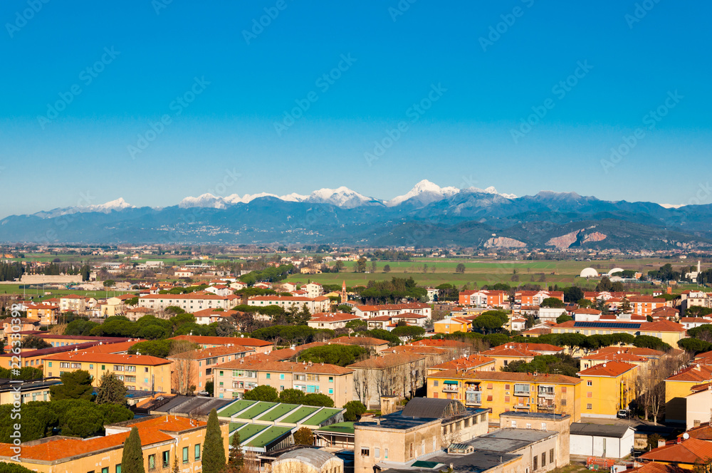 Spectacular view on the Pisa city from the height with mountain peaks and snow on the background