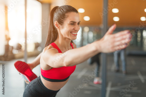 Cheerful woman training in gym