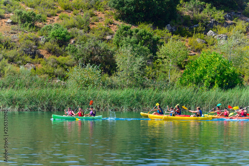 Lagunas de Ruidera, Spain - September 22, 2018: A large group of young people in different canoes having fun in the Lagunas de Ruidera.