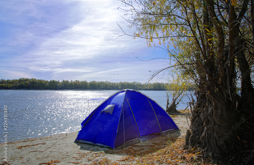 Autumn morning landscape, tent on the river bank