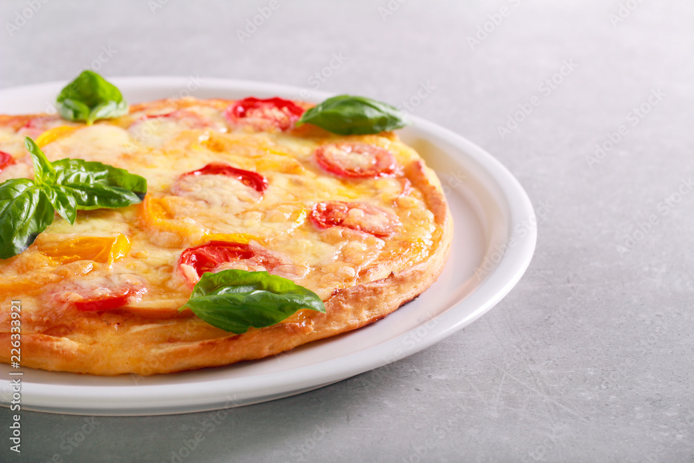 Fresh homemade pizza with basil on top Fresh homemade pizza with basil on top