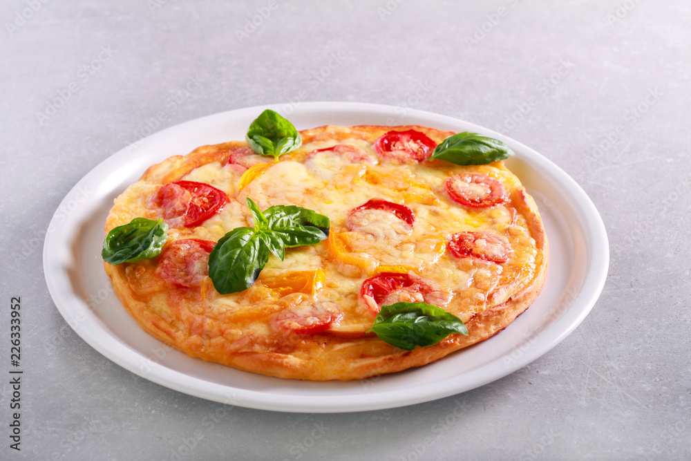 Fresh homemade pizza with basil on top Fresh homemade pizza with basil on top