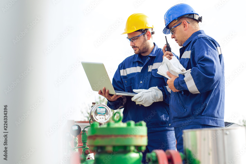 Engineer power and energy using laptop on location site Engineer power and energy using laptop on location site