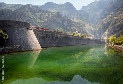 Kotor, Montenegro. Old fortress of Kotor, Montenegro in summer. Tower and wall, mountain at the background. 