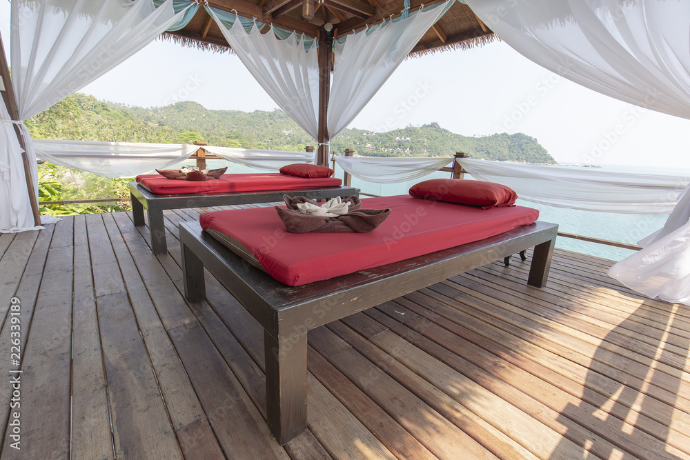 Fototapeta premium Massage table overlooking the sea. Spa massage room on the beach in Thailand